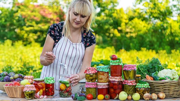 Woman with jar preserved vegetables for winter. Selective focus. Food.