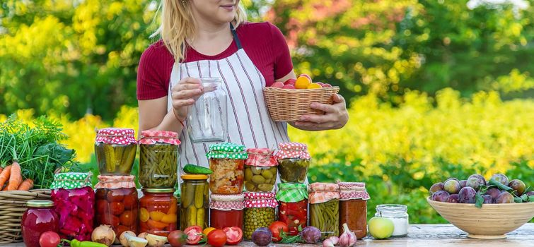 Woman with jar preserved vegetables for winter. Selective focus. Food.