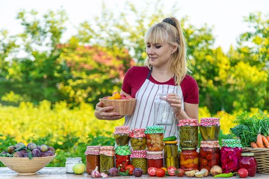 Woman with jar preserved vegetables for winter. Selective focus. Food.