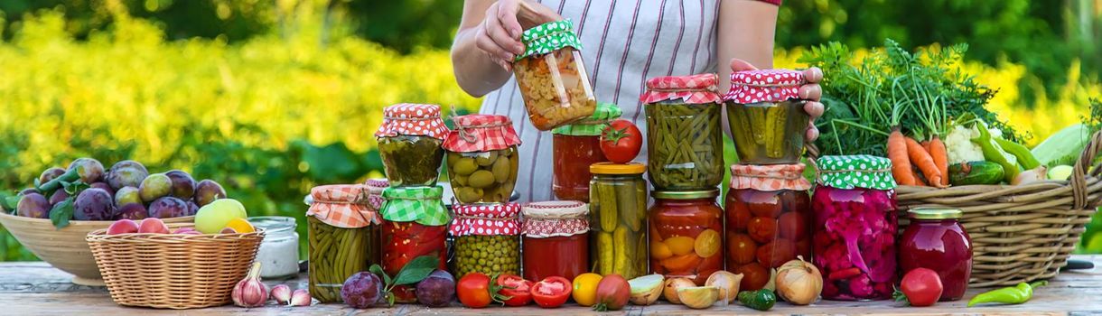 Woman with jar preserved vegetables for winter. Selective focus. Food.