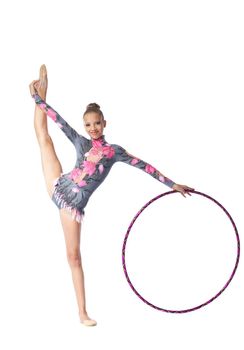 Young beautiful girl professional gymnast stand on a splits with hoop