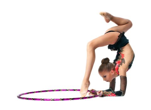 Young teenager girl stand on hands with hoop isolated