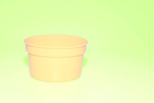 a wide mouthed cylindrical container made of glass or pottery and typically having a lid, used especially for storing product. Yellow plastic jar capacity of isolated on green