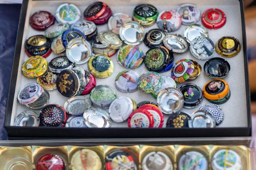 DIEPPE, FRANCE - NOVEMBER 17, 2019: Collection of champagne lids on a flea market for sale