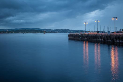 Oslofjord at evening with dramatic sky and pier, Oslo, Norway, Scandinavia