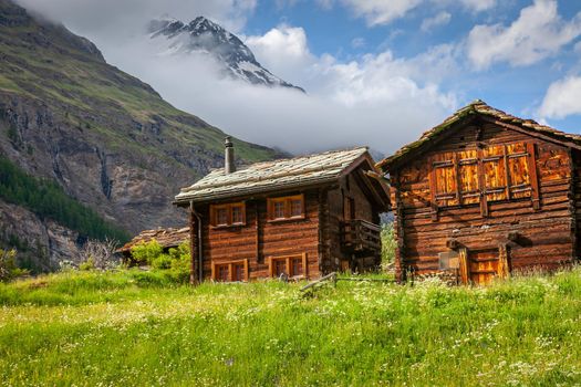 Idyllic swiss landscape with farm barns and wildflowers, Valais, Switzerland