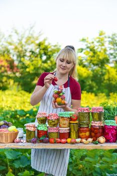 Woman with jar preserved vegetables for winter. Selective focus. Food.