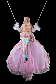 Pretty girl in fary-tale doll costume fly on wire