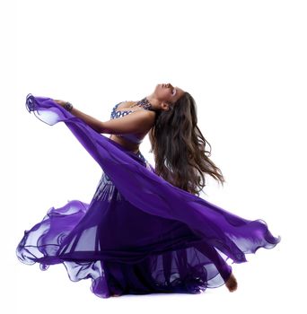 beauty young girl dance in purple arabic oriental costume with flying veil isolated