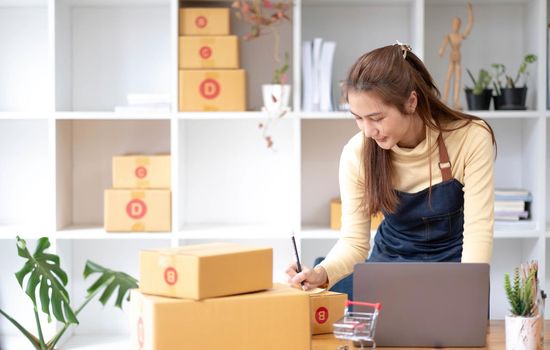 Starting small businesses SME owners female entrepreneurs Write the address on receipt box and check online orders to prepare to pack the boxes, sell to customers, sme business ideas online..