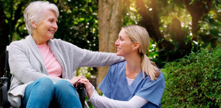 I am grateful to have you. a cheerful elderly woman in a wheelchair spending time with her daughter outside in a park