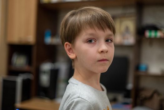 Head shot of healthy kid, Portrait happy child looking at camera with smiling face, candid shot cute little boy relaxing stay at home during covid lock down.Positive children concept, Social distancing.
