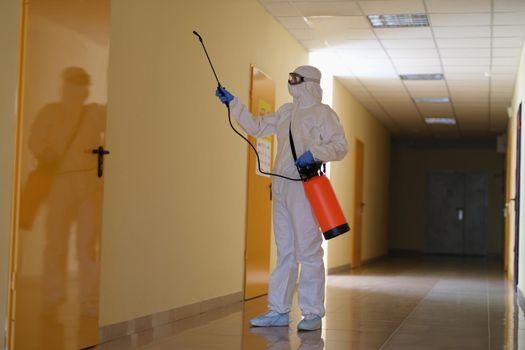 Disinfector in means of protection disinfection of premises from viruses and infections. Sanitary service concept