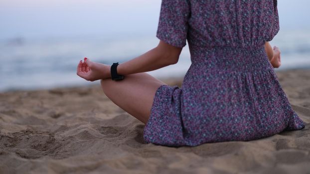 Cropped shot of unrecognizable young woman meditating on beach.Time to meditate
