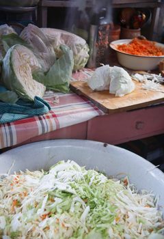 Cabbage in basin prepared for home made sauerkrauting in old farm kitchen, selective focus.