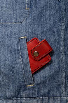 Luxury craft business card holder case made of leather. Red Leather box for cards in a pocket of jeans jacket.