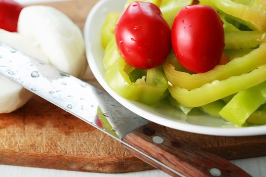 Closeup of various chopped vegetables on cutting board