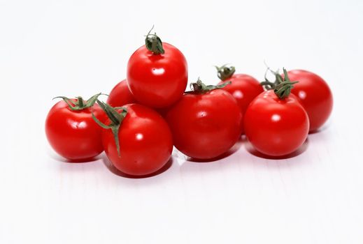 Heap of nice freshness red tomatoes on white table