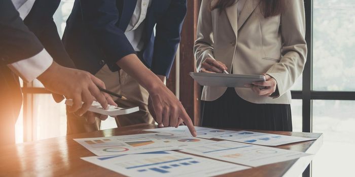 Asian business adviser meeting to analyze and discuss the situation on the financial report in the meeting room.Investment Consultant,Financial Consultant,Financial advisor and accounting concept.