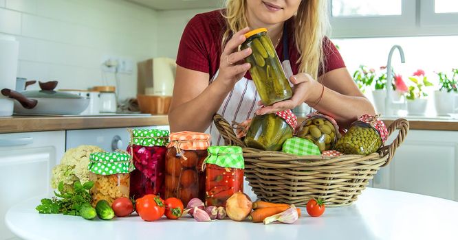 Woman jar preserve vegetables in the kitchen. Selective focus. Food.