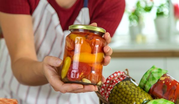 Woman jar preserve vegetables in the kitchen. Selective focus. Food.