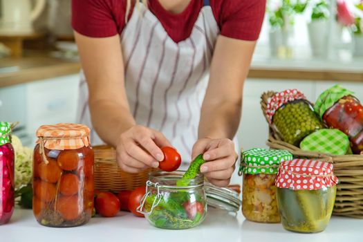 Woman jar preserve vegetables in the kitchen. Selective focus. Food.