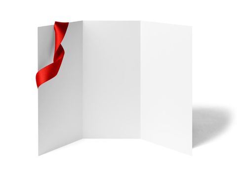 close up of a note card or leaflet brochure with ribbon bow on white background