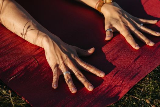 Close Up Unrecognisable Woman Holding Her Hands on Mat During Yoga Outdoors at Sunset