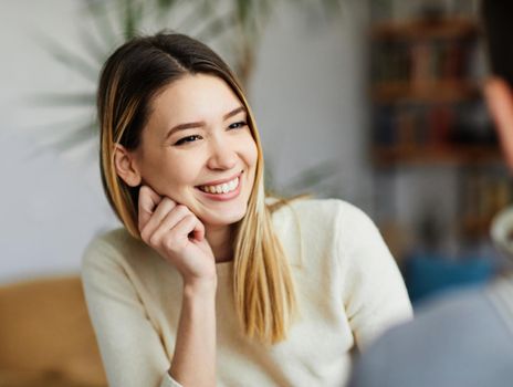 Portrait of a young happy girl talking with a friend