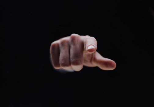 Hand isolated on black background with index finger extended