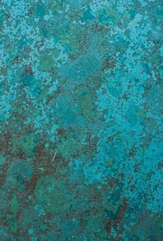 Turquoise blue wall or metal fence surface with dark small spots. Design background with place for text.