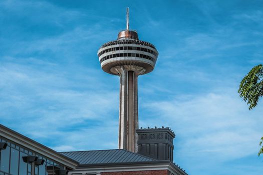 Niagara Falls, Ontario Canada - August 29, 2019: Beautiful view of skylon tower at Niagara falls with blue sky and green trees