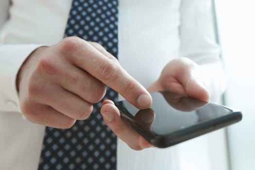 Businessman using phone for celling and texting on her mobile phone