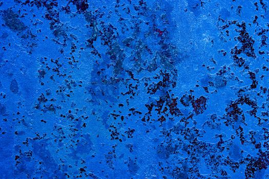 Abstract blue texture of an old wall with paint cracks. Design background with place for text.