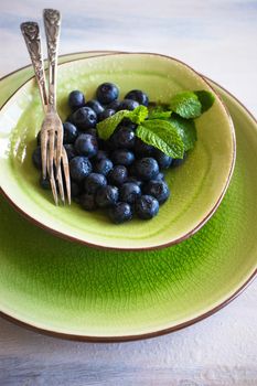 Ripe organic bilberries on dark wooden table with copyspace as a organic food concept