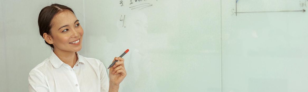 Asian business woman looking on flipboard with charts stand in meeting room. High quality photo