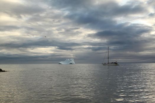 A sailboat anchored near Pond Inlet, Nunavut waiting for weather to transit through the Northwest Passage, Canada