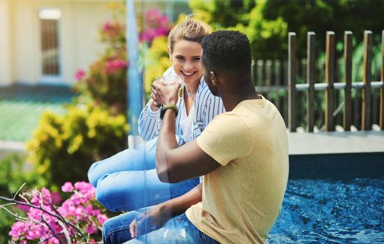 Cheers to us. a young couple enjoying drinks together while relaxing outdoors on holiday