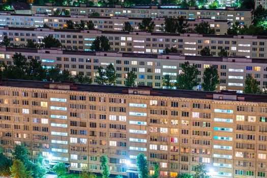 Timelapse of residential quarters of the night city with the lights on from the windows of the apartments