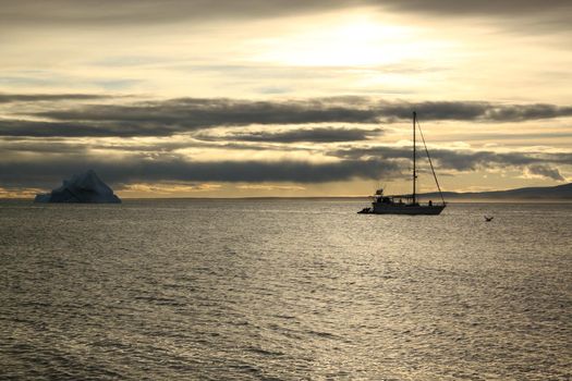 A sailboat anchored near Pond Inlet, Nunavut waiting for weather to transit through the Northwest Passage, Canada