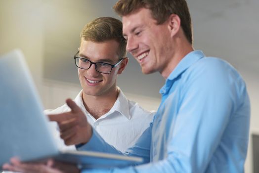 Thats the section I was talking about. two handsome young businessmen working on a laptop together at work