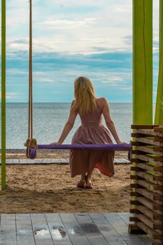 Swing happy travel sea beach summer woman leisure beautiful tourist, from dream concept for water from relaxation people, idyllic ocean. Joy sunset fun, swinging