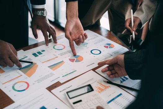 Business people discuss investment project working and planning strategy and using calculator during a business meeting