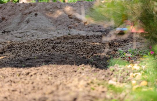 Plowed land, agricultural work. Leveling the soil on the site.Close-up.