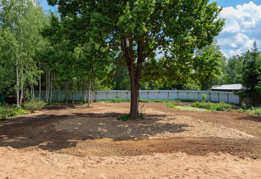 Plowed land, agricultural work. Leveling the soil on the site.