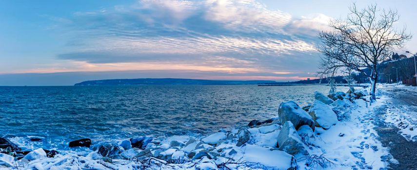 Winter landscape, sunrise, or sunset at the shore. Panoramic view