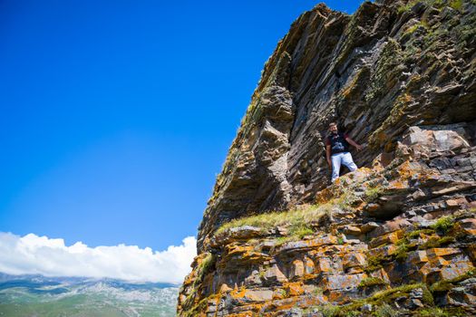 A man stands on top of a mountain, North Ossetia, the village of Kamunta