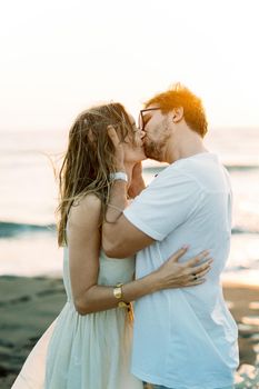 Man kissing a woman holding her head in his hands. High quality photo