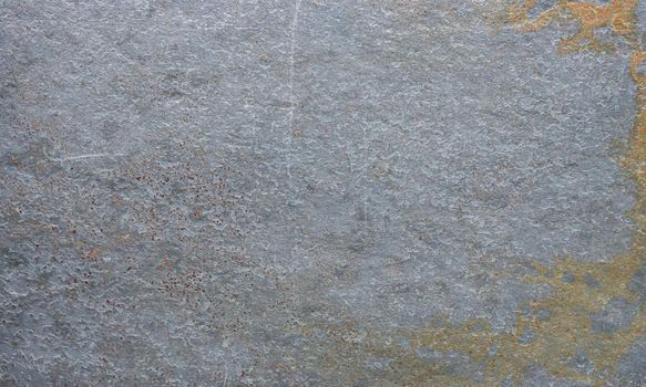 Gray stone surface covered with rust, mold. Close-up photo of an abandoned concrete wall.