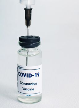 Ampoule with a vaccine. and syringe on white background. Vaccine against a white background..